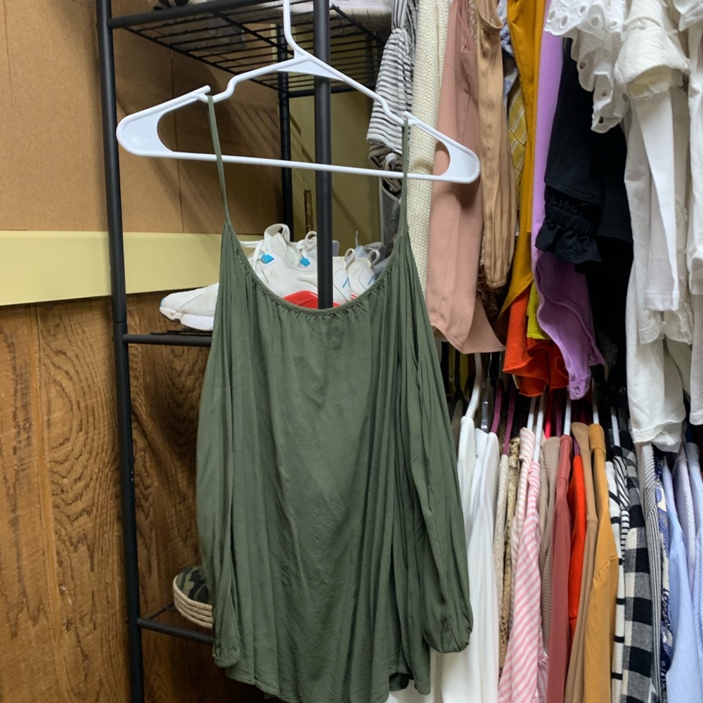 A green off the shoulder shirt